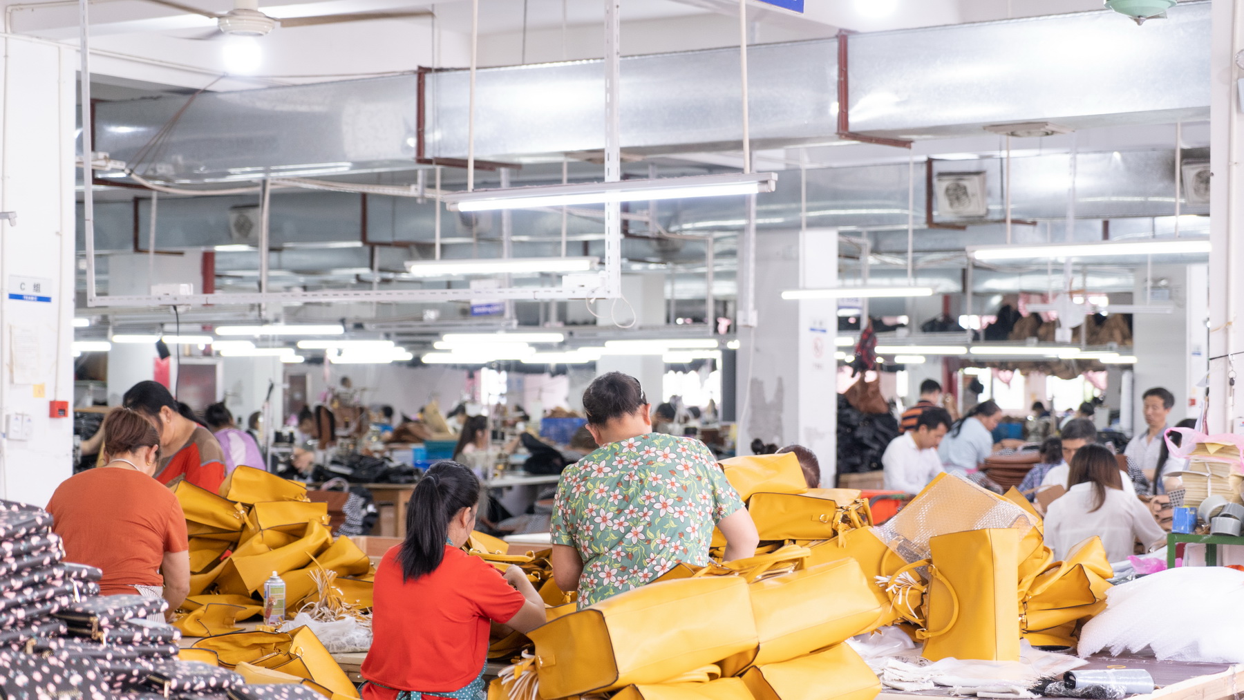 Factory team handling yellow bags during production