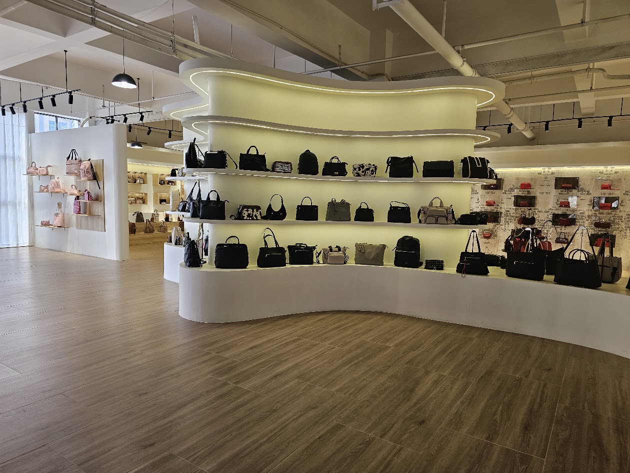 Showroom display wall with a range of bags