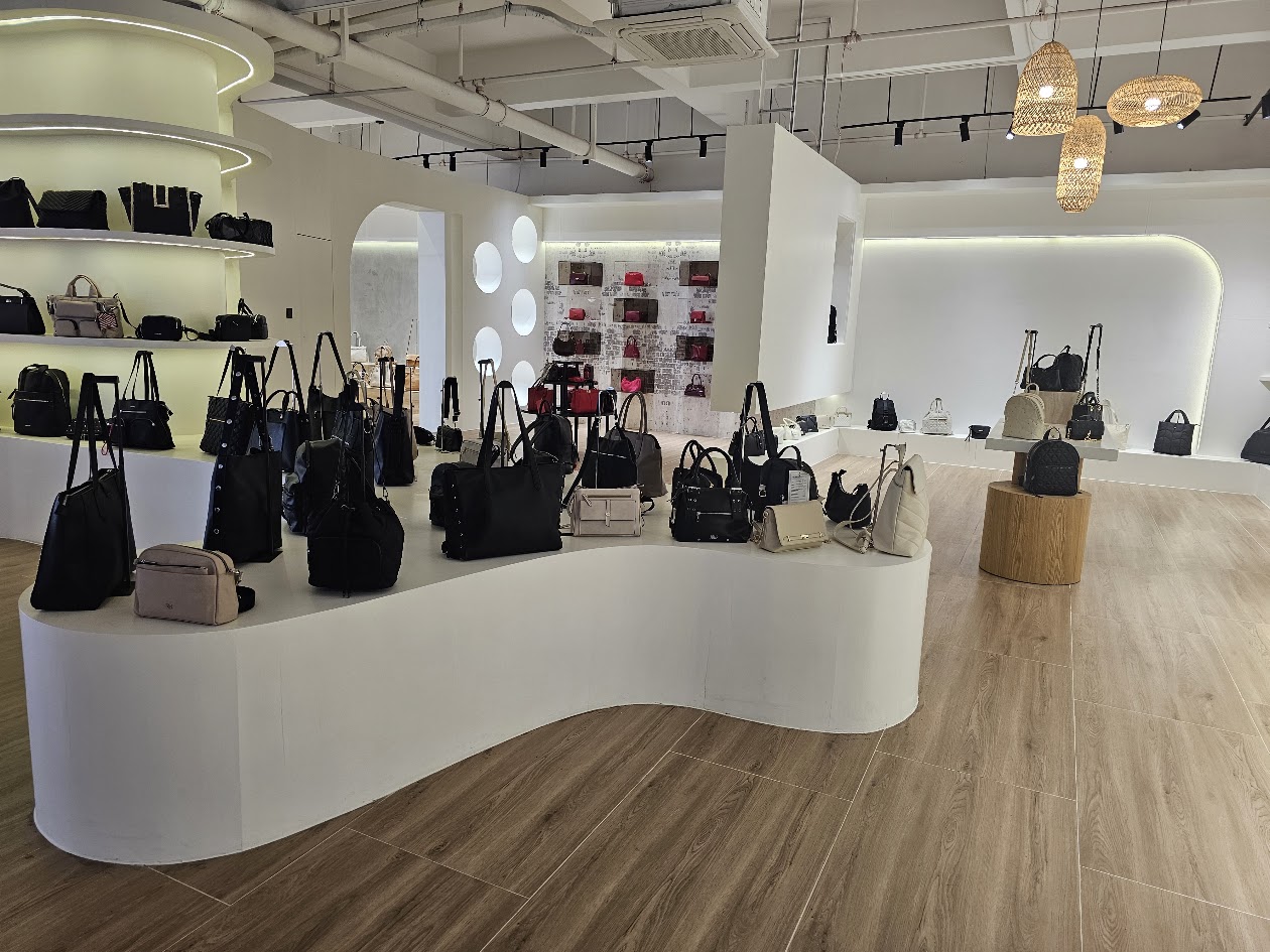 Showroom display area with handbags and shelves