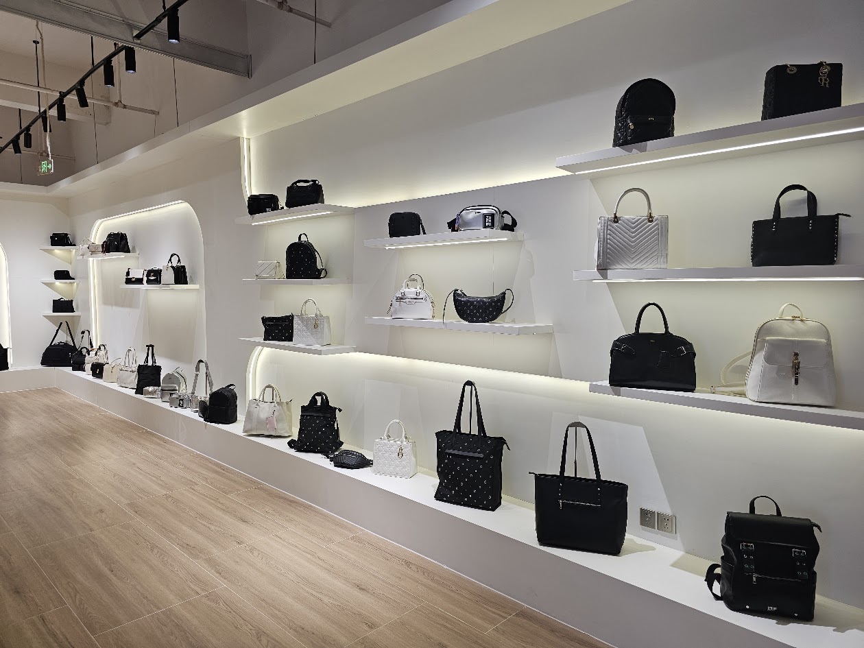 Close view of bags displayed along a showroom wall
